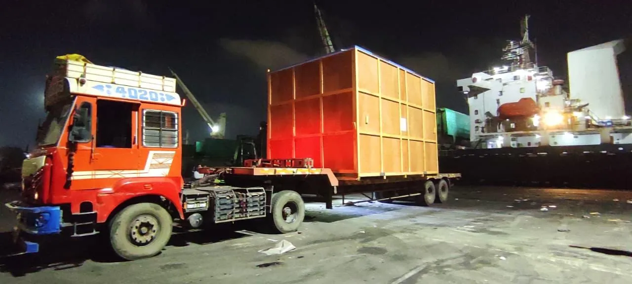 Wooden export crate on a trailer at the port at night