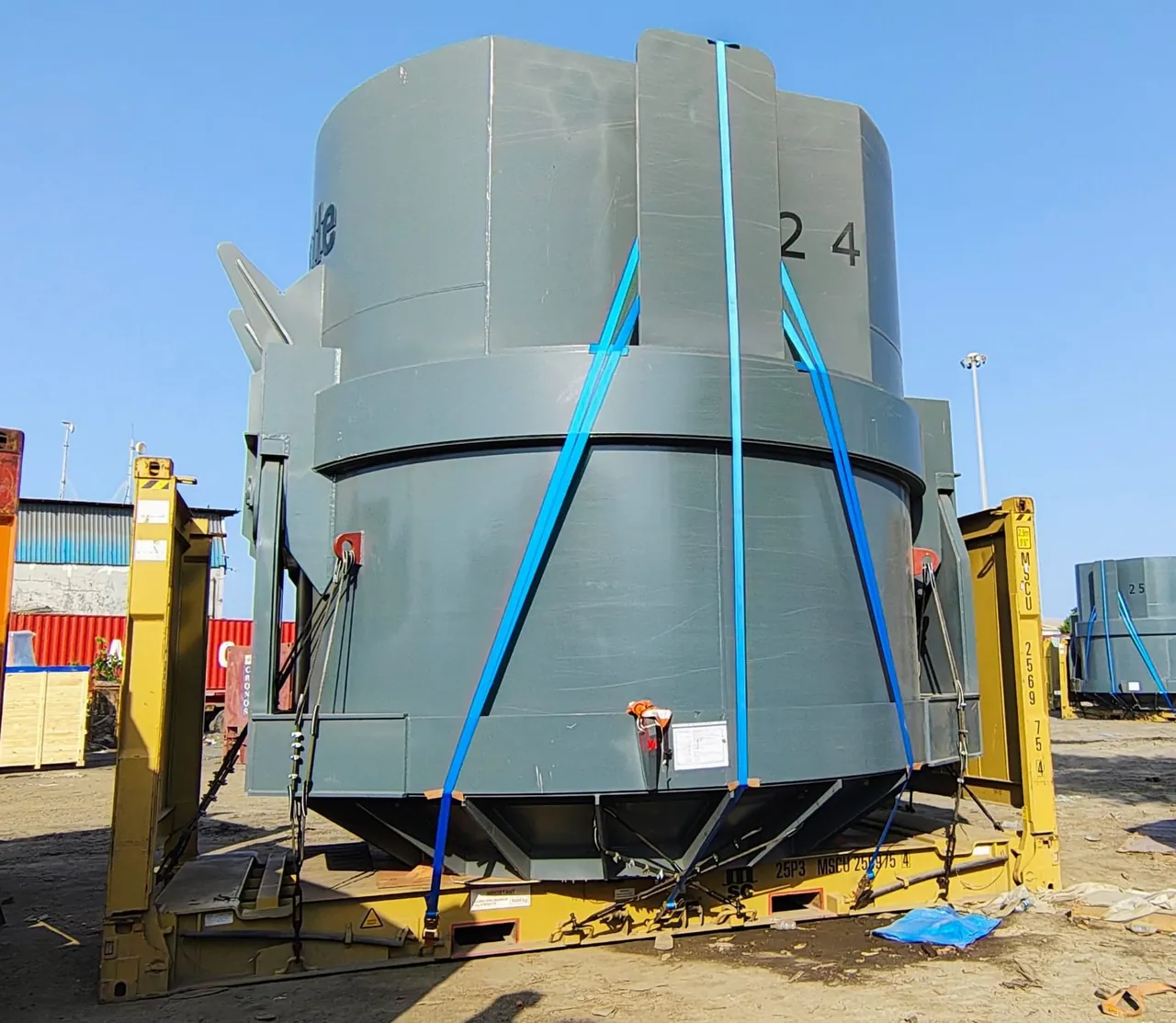 Large steel vessel secured with straps on a flat rack